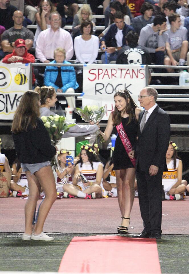 Homecoming court member Jesse Dorse is escorted by her father Kevin during halftime at the La Cañada High School football game on Friday, Oct. 16, 2015.