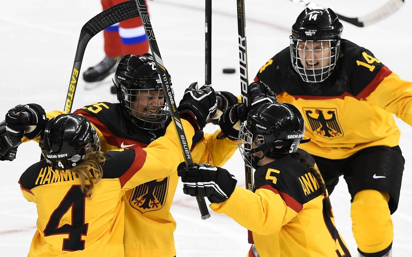 Germany's Franziska Busch, left, celebrates with her teammates after scoring a goal during the women's ice hockey match between Russia and Germany at the Shayba Arena.