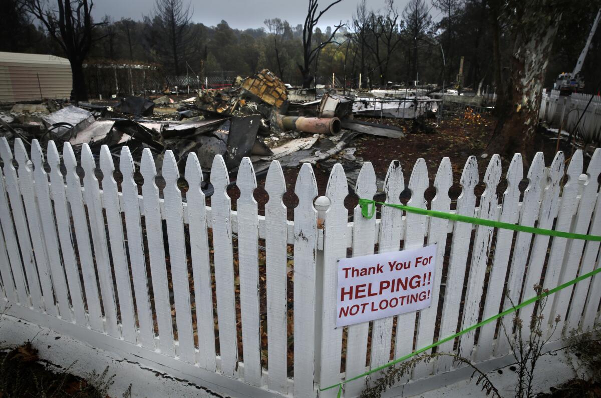 A sign on a fence in a Middletown neighborhood addresses the recent looting of homes that have been evacuated in the wake of the Valley fire.