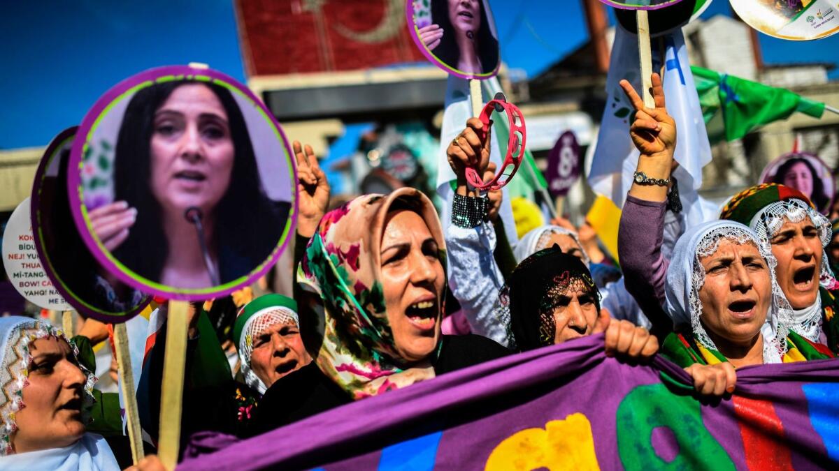 Women chant slogans and hold pictures of Figen Yuksekdag, co-leader of the pro-Kurdish People's Democratic Party, on March 5, 2017, in Istanbul, Turkey.