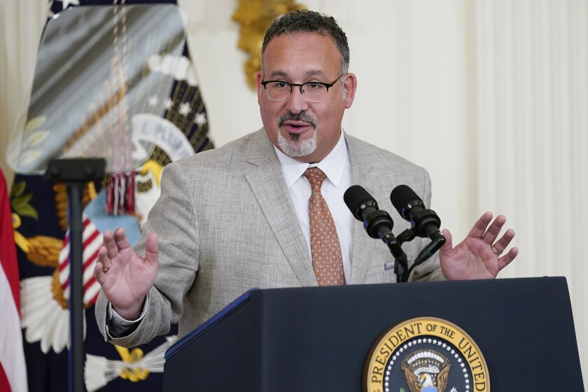 Education Secretary Miguel Cardona speaks in the East Room of the White House