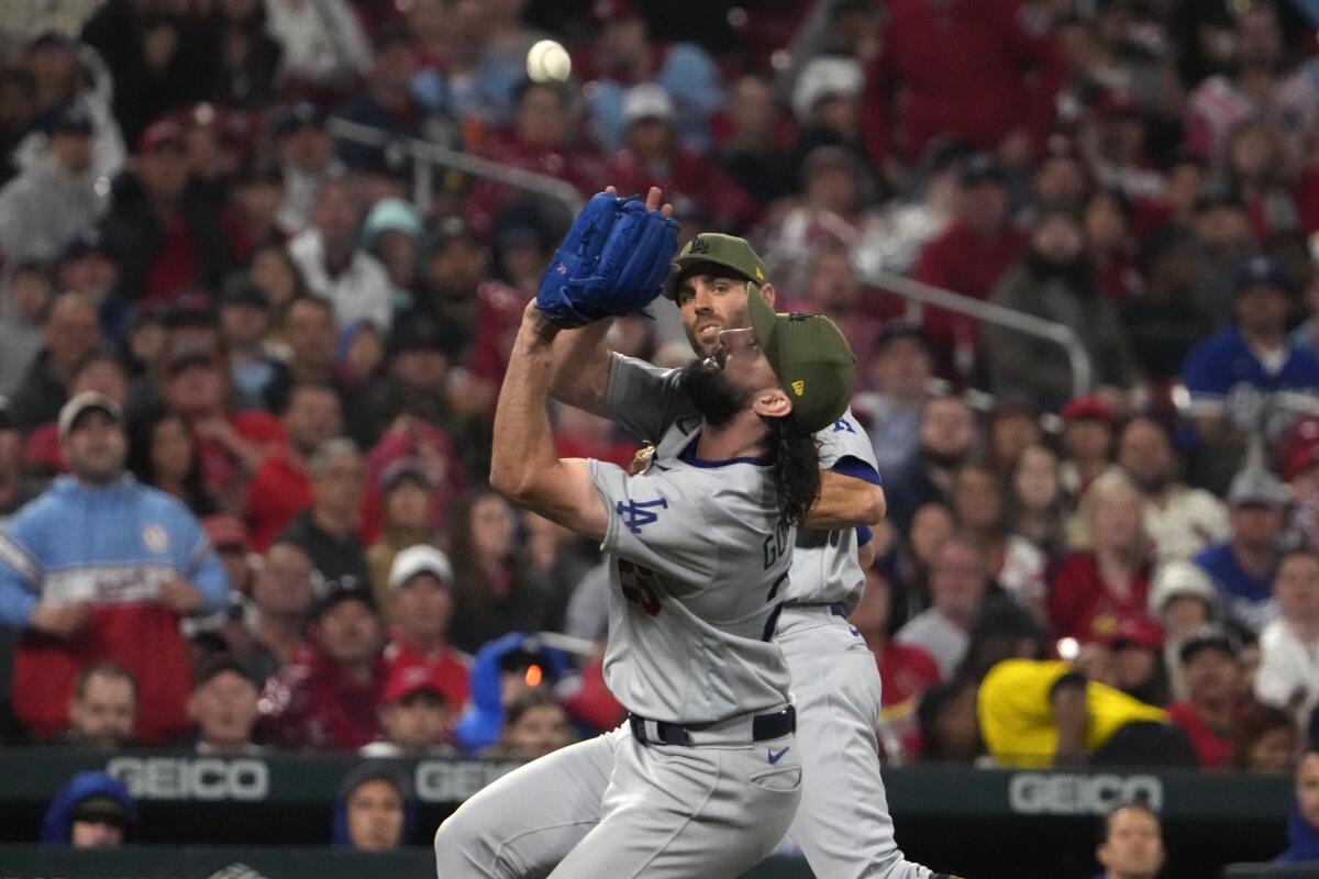 Dodgers starting pitcher Tony Gonsolin, front, catches a pop up off the bat of the Cardinals' Paul DeJong.