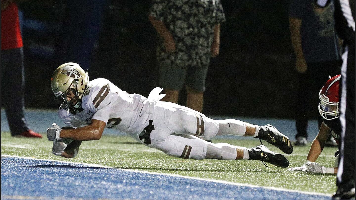 St. Francis' Elijah Washington dives to the end zone, pulling his feet free from a La Salle defender, to score in an Angelus League football game at La Salle High School in Pasadena on Thursday, October 12, 2017.