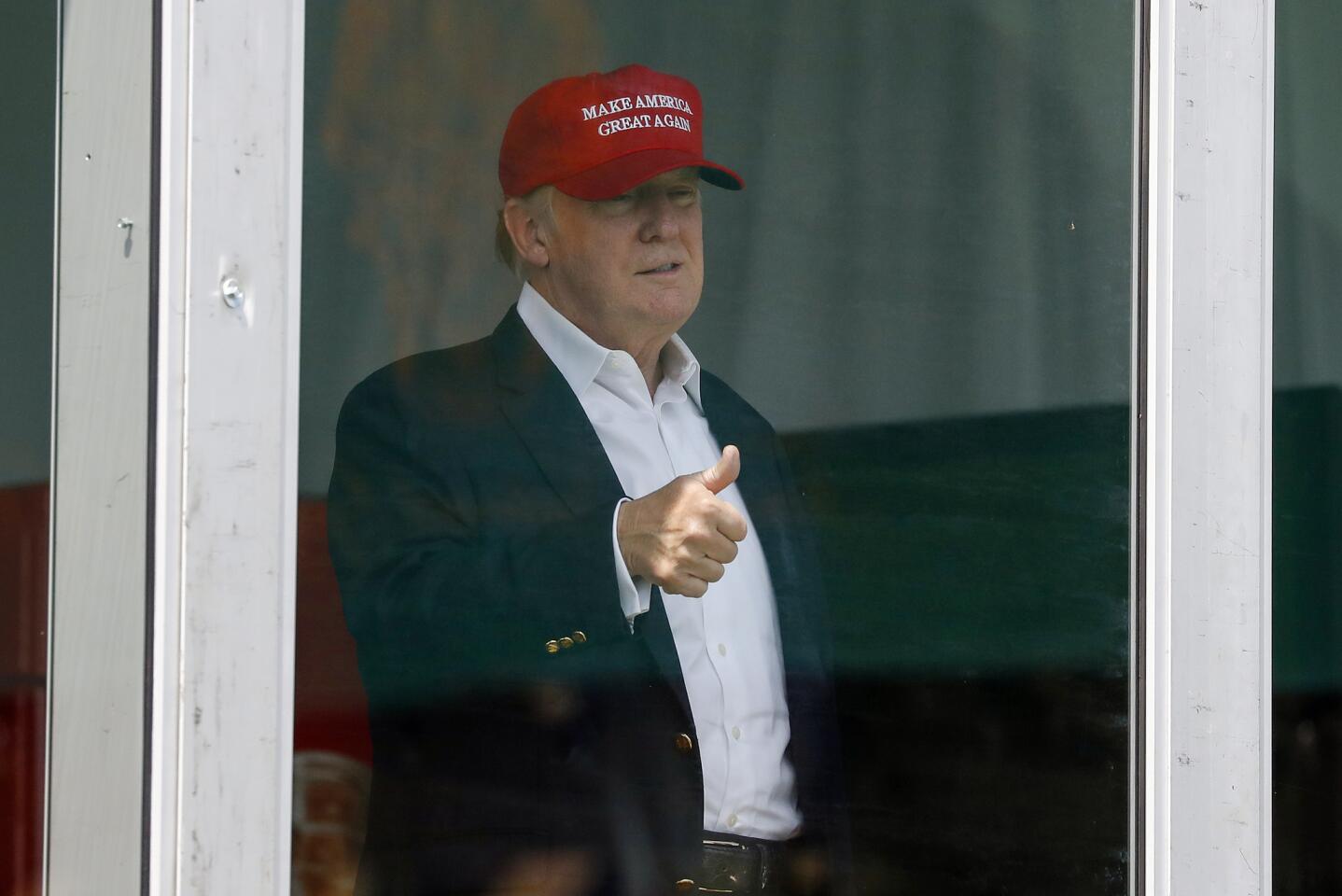 President Donald Trump gives the thumbs-up from his presidential viewing stand Saturday, July 15, 2017, during the U.S. Women's Open Golf tournament at Trump National Golf Club in Bedminster, N.J.