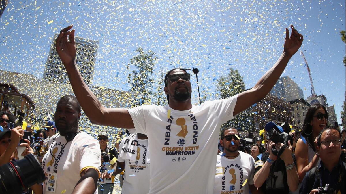 NBA Finals MVP Kevin Durant enjoys the moment with Warriors fans.