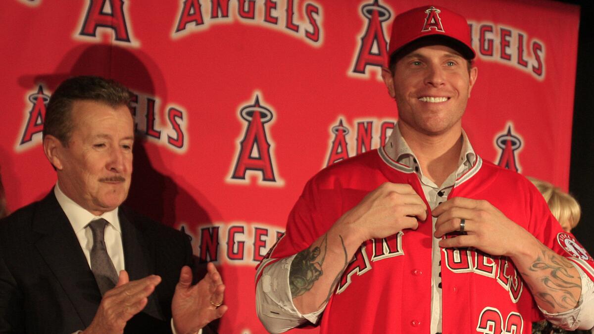 With the Angels still paying the contract of Josh Hamilton, right, owner Arte Moreno, left, is reluctant to go after a big-name bat.