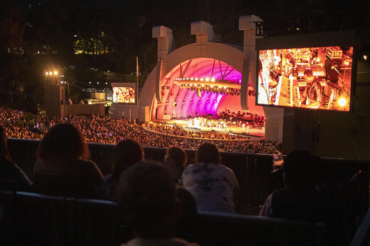 A crowd watching a concert at night at the Hollywood Bowl