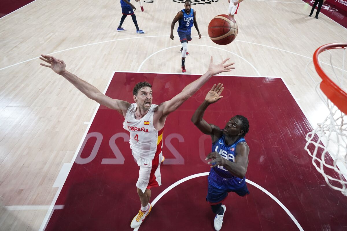 Spain's Pau Gasol (4) fights for a rebound with United States' Jrue Holiday, right, during a men's basketball quarterfinal round game at the 2020 Summer Olympics, Tuesday, Aug. 3, 2021, in Saitama, Japan. (AP Photo/Charlie Neibergall, Pool)