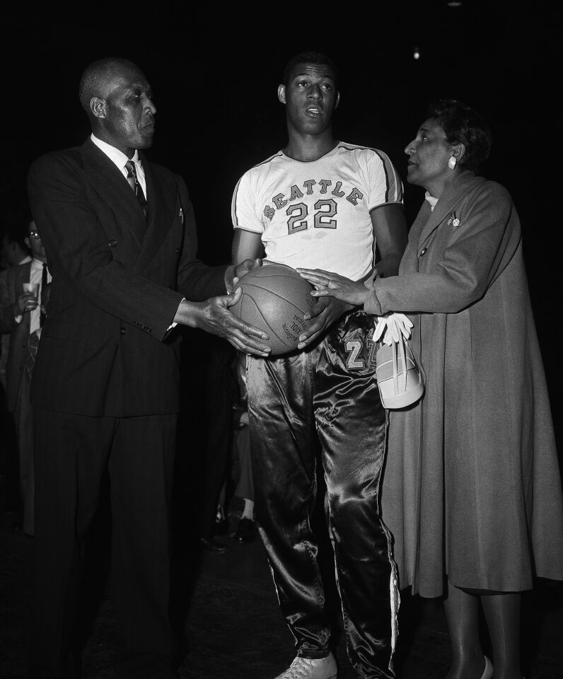 Mr. and Mrs. John W. Baylor with their son Elgin as he gets ready to play for the Seattle University team in the National Invitation Tournament in Madison Square Garden in New York on March 18, 1957.