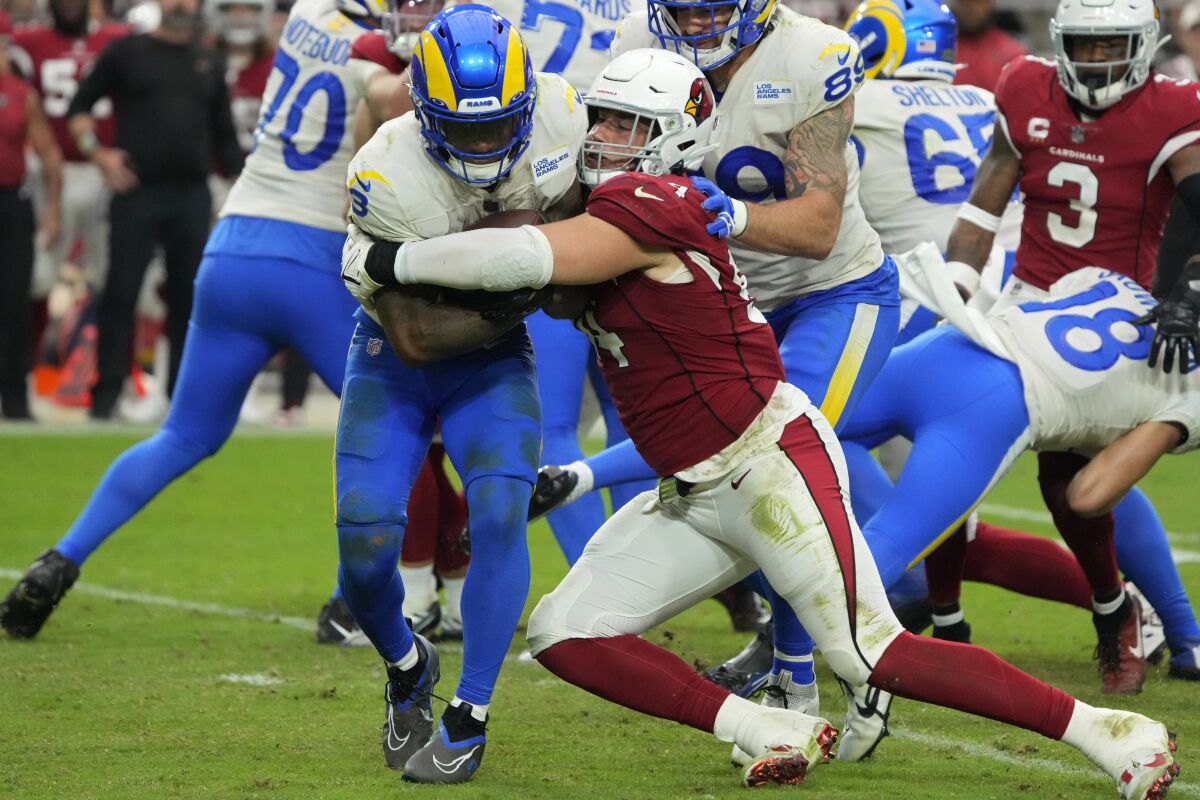 Cardinals defensive end Zach Allen (94) tackles Rams running back Cam Akers.