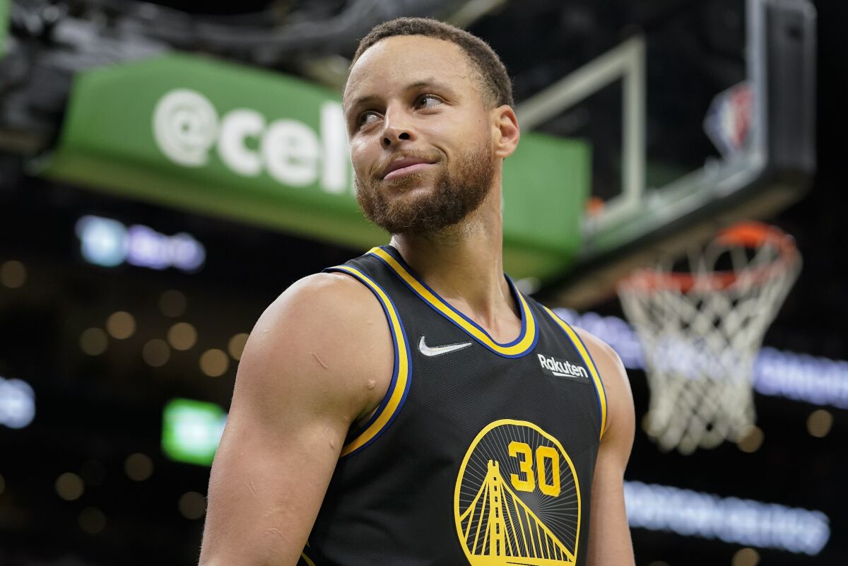 Golden State Warriors guard Stephen Curry (30) reacts after the Warriors defeated the Boston Celtics in Game 4 of basketball's NBA Finals, Friday, June 10, 2022, in Boston. (AP Photo/Steven Senne)