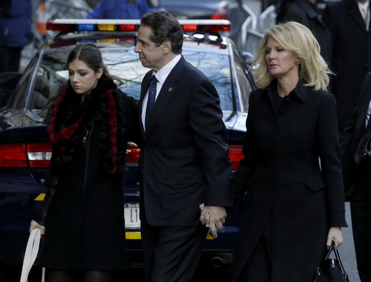 New York Gov. Andrew Cuomo arrives at his father's wake in Manhattan. With him are his daughter, Michaela, left, and his girlfriend, Sandra Lee.