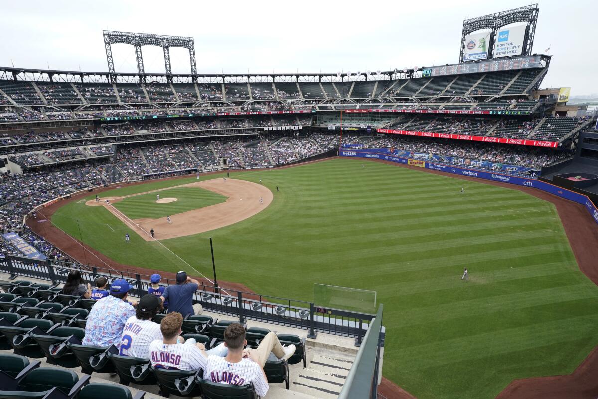 New York Mets fans watch a baseball game against the Washington Nationals during the seventh inning, Sunday, Aug. 29, 2021, in New York. (AP Photo/Corey Sipkin)