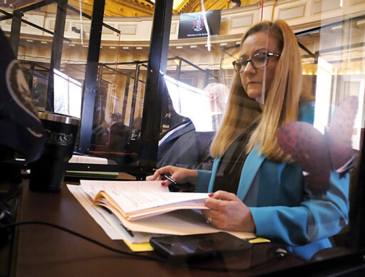 Sen. Amanda Chase, R-Chesterfield, looks over the day's calendar during the floor session of the Virginia Senate inside the State Capitol in Richmond, Va., on Monday, Jan. 24, 2022. (Bob Brown/Richmond Times-Dispatch via AP)