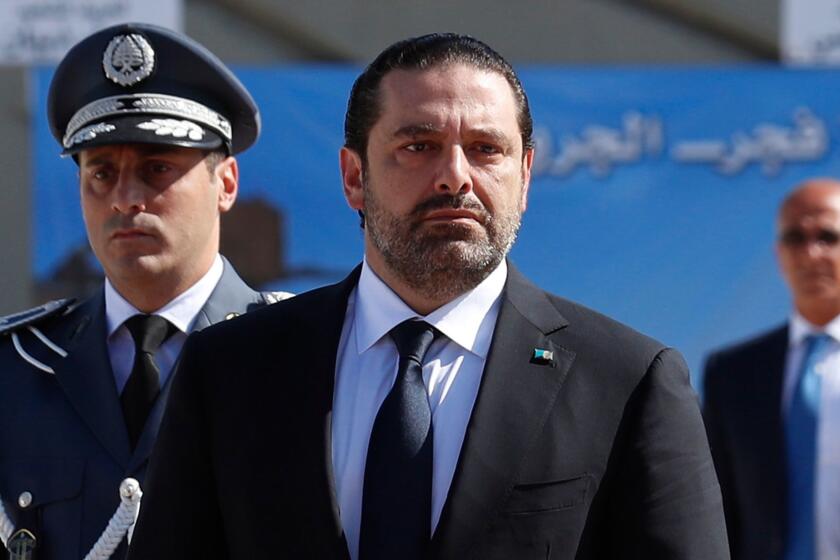 In this photo taken on Friday, Sept. 8, 2017, Lebanese Prime Minister Saad Hariri, left, arrives for a mass funeral of ten Lebanese soldiers at the Lebanese Defense Ministry, in Yarzeh near Beirut, Lebanon. Lebanese prime minister Saad Hariri has announced he is resigning in a surprise move following a trip to Saudi Arabia. In a televised address Saturday, Nov. 4, he slammed Iran and the Lebanese Hezbollah group for meddling in Arab affairs and says "Iran's arms in the region will be cut off." (AP Photo/Hassan Ammar)
