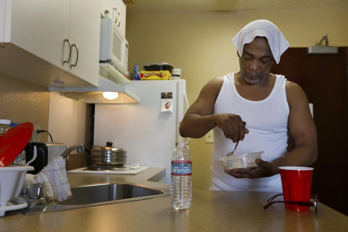 Maurice Caldwell makes oatmeal for breakfast in the hotel room he calls home in Sacramento.