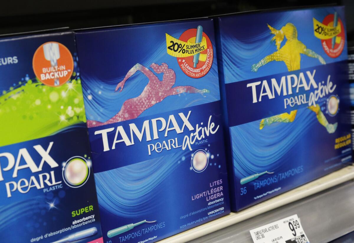 Boxes of tampons are displayed in a pharmacy in New York. A group of women has filed a lawsuit accusing the state of unlawfully taxing feminine hygiene products, arguing that medical items are exempt from sales tax.