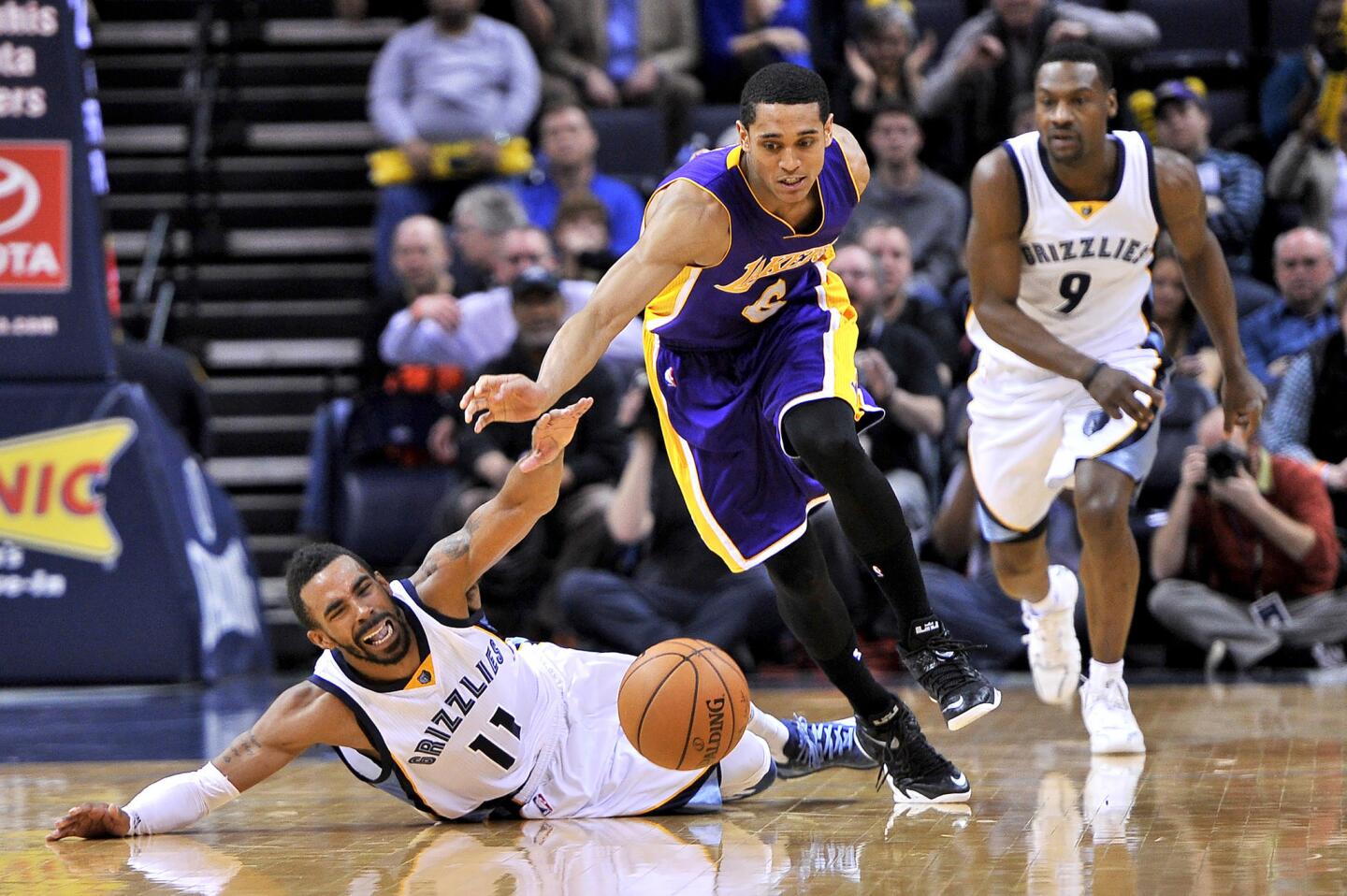 Grizzlies point guard Mike Conley falls to the court as Lakers point guard Jordan Clarkson steals the ball in the second half.