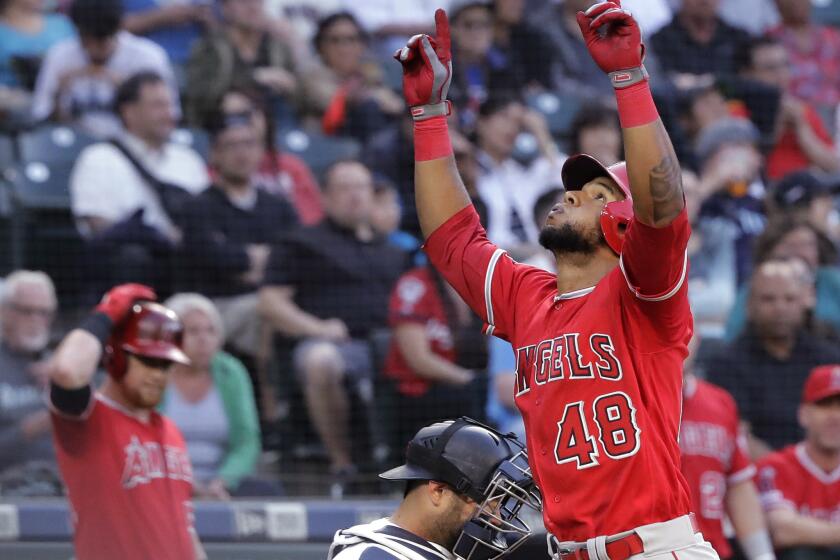 Los Angeles Angels' Cesar Puello (48) reacts as he crosses the plate after hitting a solo home run during the third inning of the team's baseball game against the Seattle Mariners, Thursday, May 30, 2019, in Seattle. (AP Photo/Ted S. Warren)