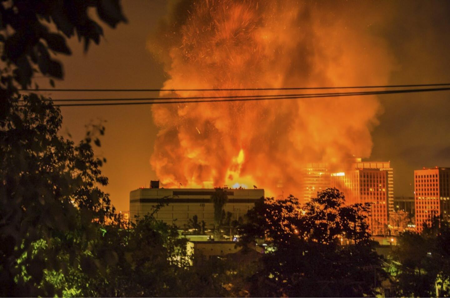 More than 200 firefighters work to control a massive fire as it destroys a seven-story building under construction in downtown Los Angeles.