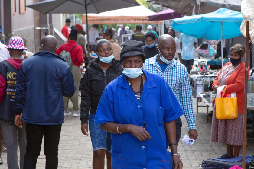 A woman, wearing a mask to protect against COVID-19 in Soweto, South Africa