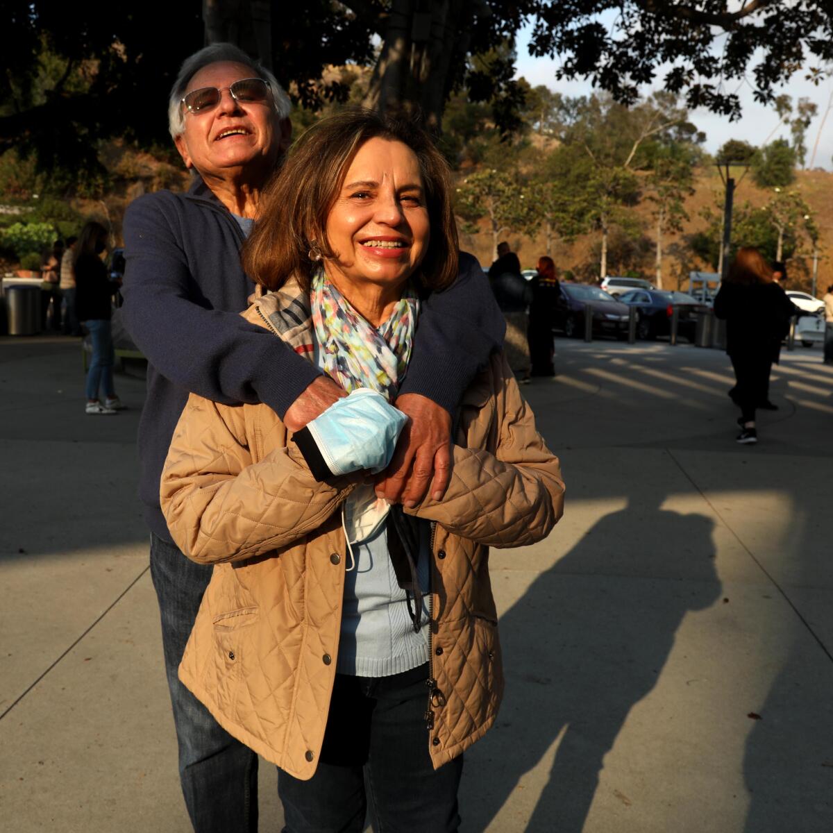 A man and woman pose for a photo.