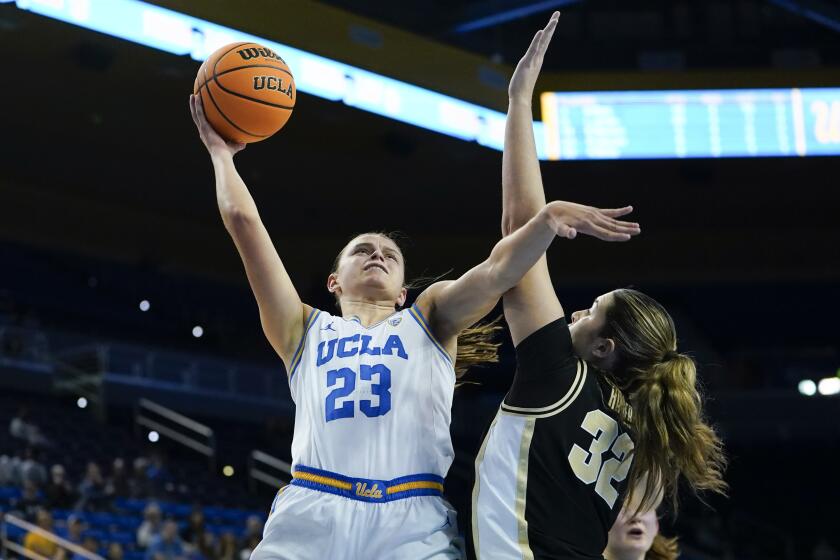UCLA forward Gabriela Jaquez, left, shoots over Purdue forward Alaina Harper.