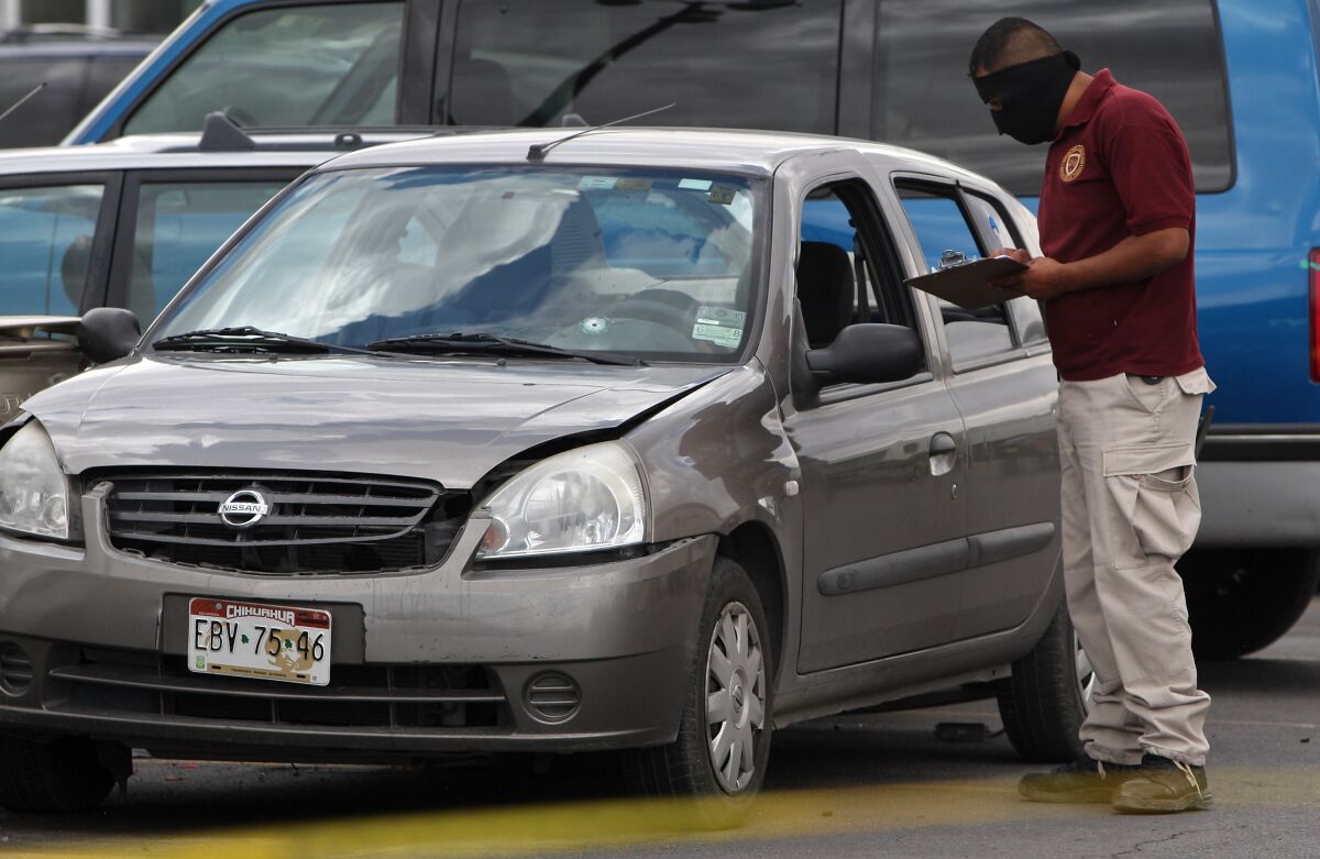 A Mexican policeman works in the scene where photojournalist Luis Carlos Santiago, of El Diario newspaper, was killed 