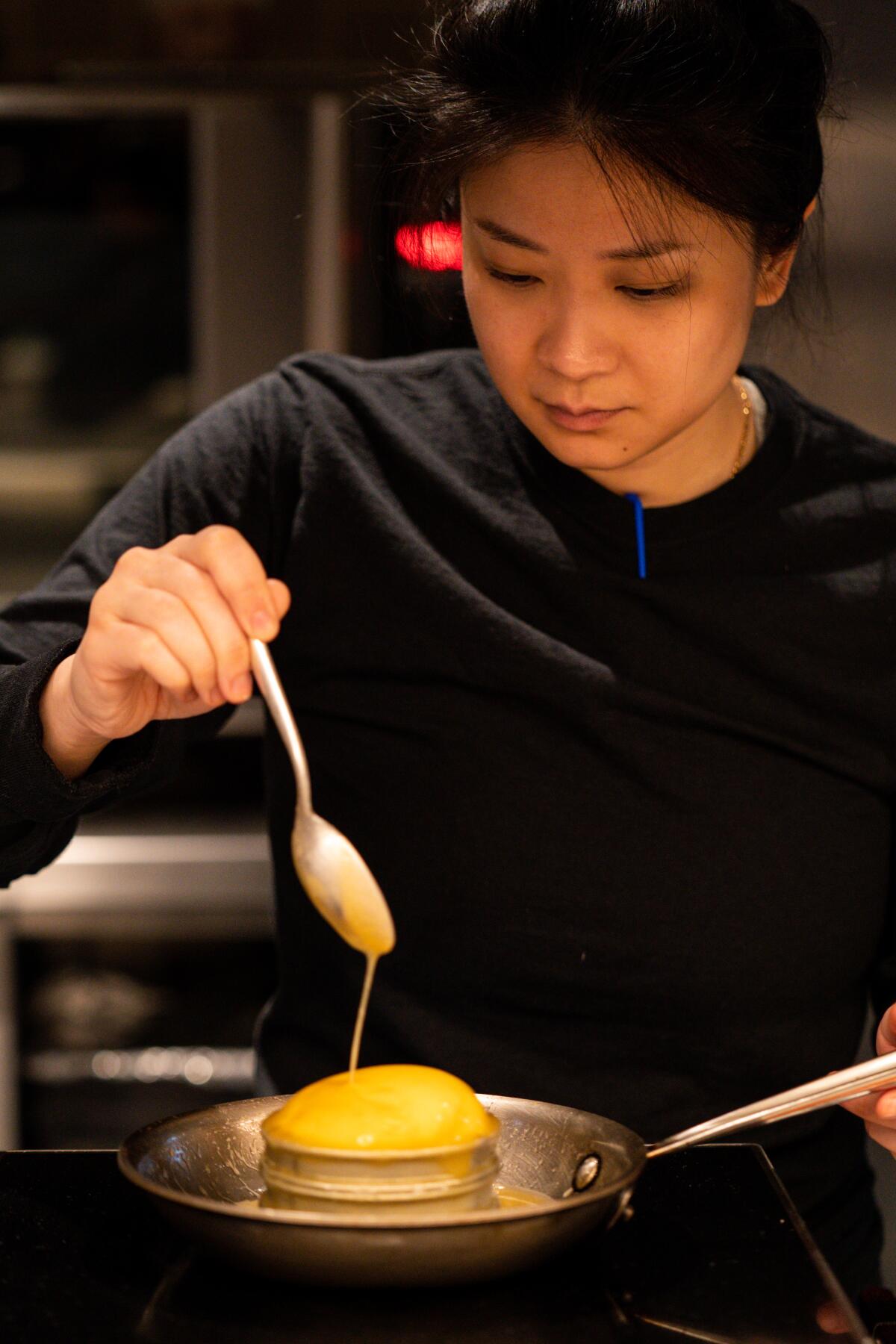 Dyan Ng basting the dough as she cooks honey butter brioche in a pan.