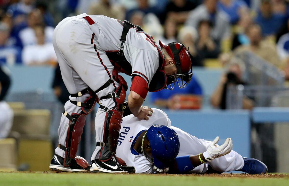 Dodgers' Yasiel Puig went down after being hit by a pitch in the sixth inning at Dodger Stadium.