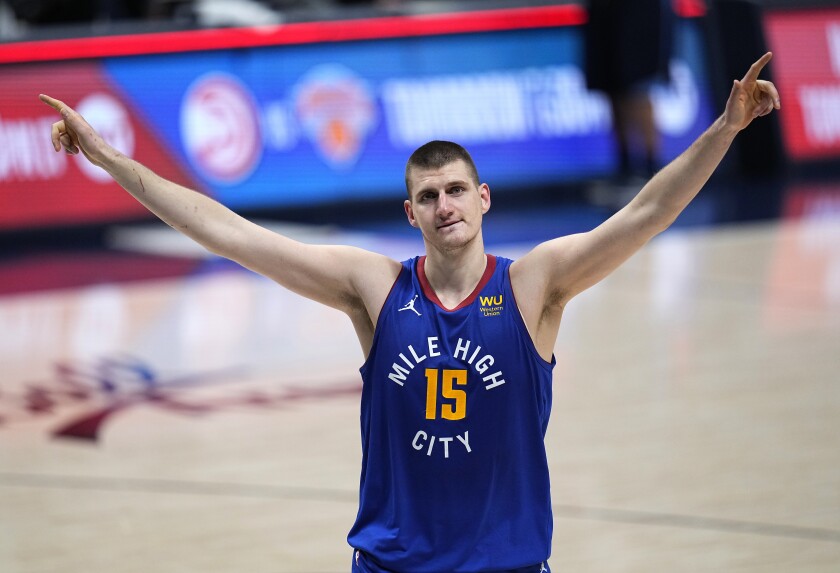 Denver Nuggets center Nikola Jokic (15) celebrate the team's double-overtime win against the Portland Trail Blazers in Game 5 of a first-round NBA basketball playoff series Tuesday, June 1, 2021, in Denver. (AP Photo/Jack Dempsey)