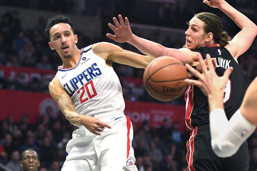 Clippers guard Landry Shamet passes the ball around Heat center Kelly Olynyk during the third quarter Feb. 5, 2020.