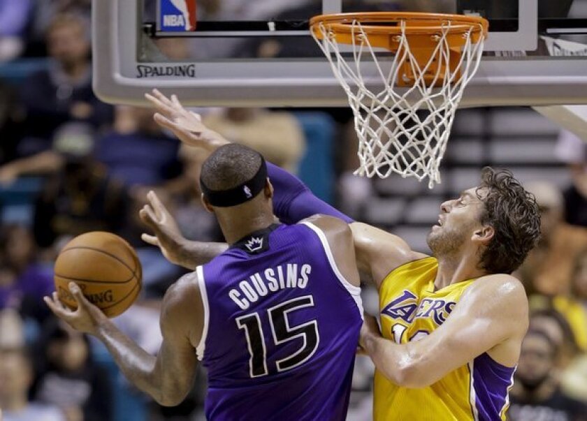 Pau Gasol goes up against DeMarcus Cousins during the Lakers' loss to the Sacramento Kings, 104-86, in Las Vegas.