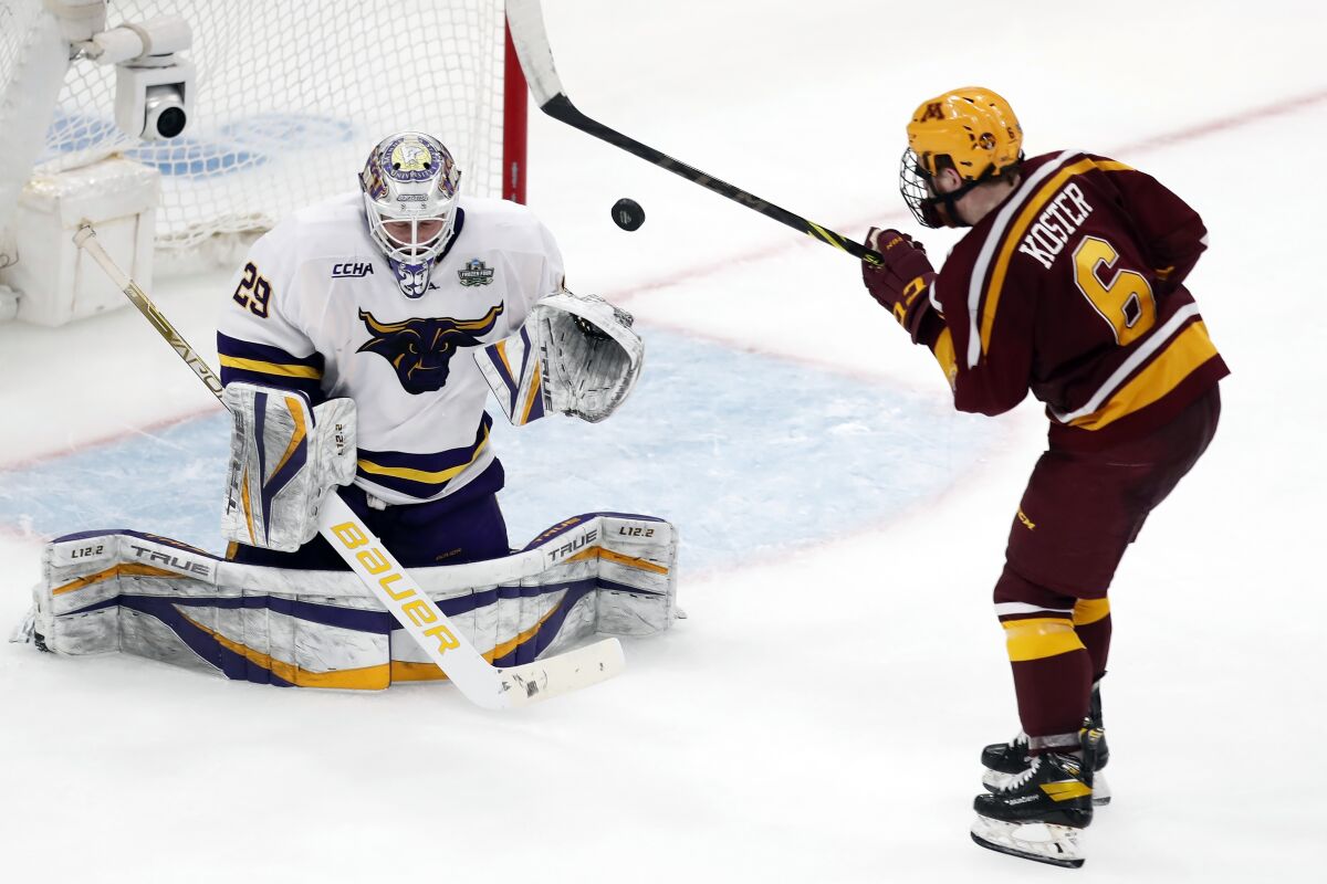Minnesota State's Dryden McKay (29) blocks a shot by Minnesota's Mike Koster (6) during the third period of an NCAA men's Frozen Four college hockey semifinal Thursday, April 7, 2022, in Boston. (AP Photo/Michael Dwyer)