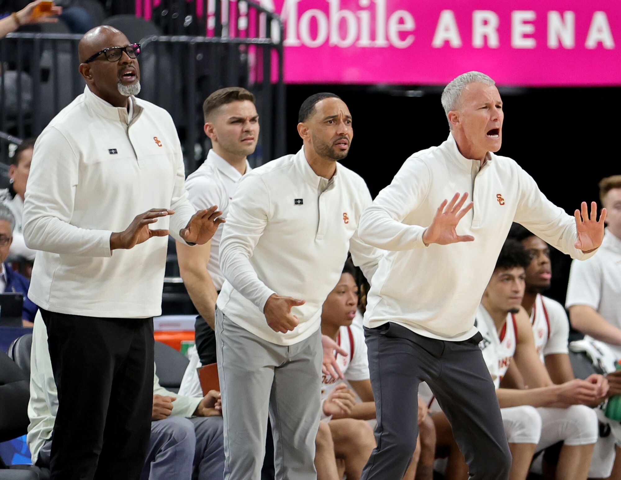 USC staff members Eric Mobley, Kurt Karis, Jay Morris and Andy Enfield react from the sideline