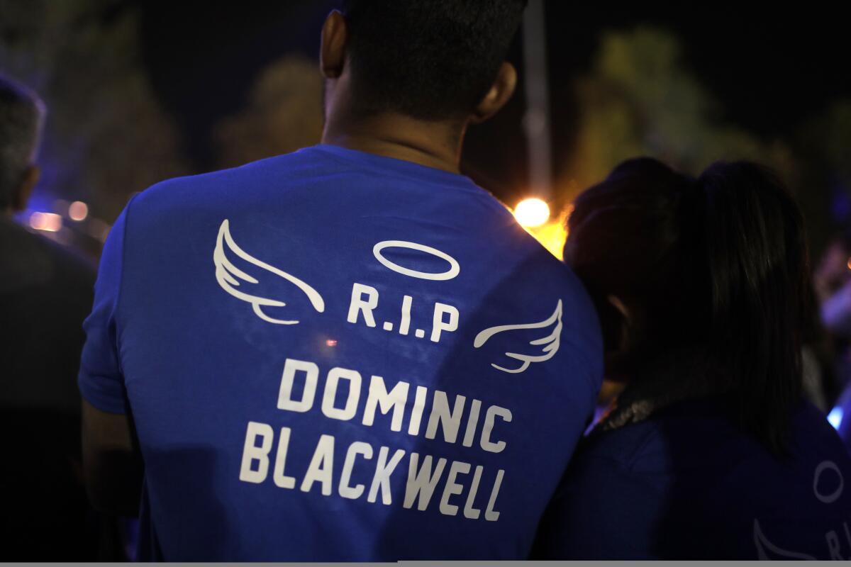 A man wears a shirt emblazoned with the name of a boy killed in the Saugus High shooting.