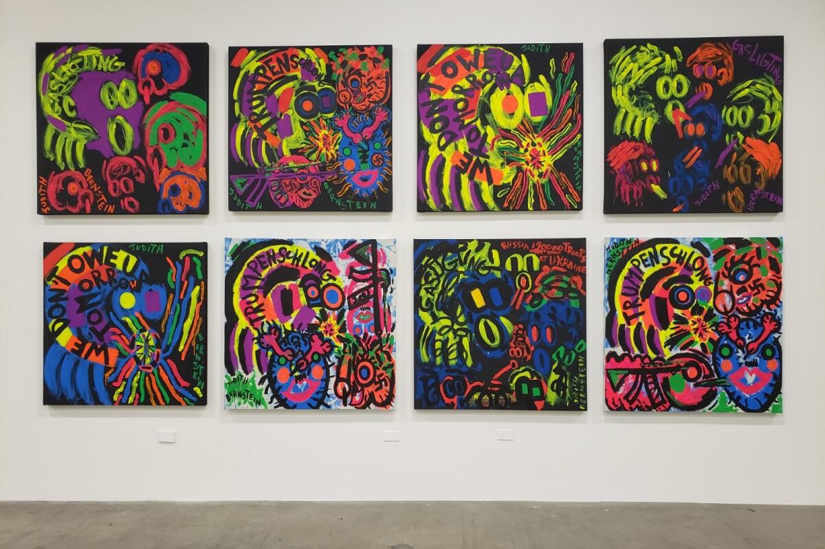 Two rows of four bright, graffiti-like paintings on a white gallery wall.