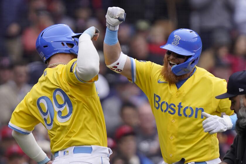 Boston Red Sox's Alex Verdugo (99) celebrates with Justin Turner as Turner arrives at home plate after hitting a two-run home run in the third inning of a baseball game against the Los Angeles Angels, Sunday, April 16, 2023, in Boston. (AP Photo/Steven Senne)