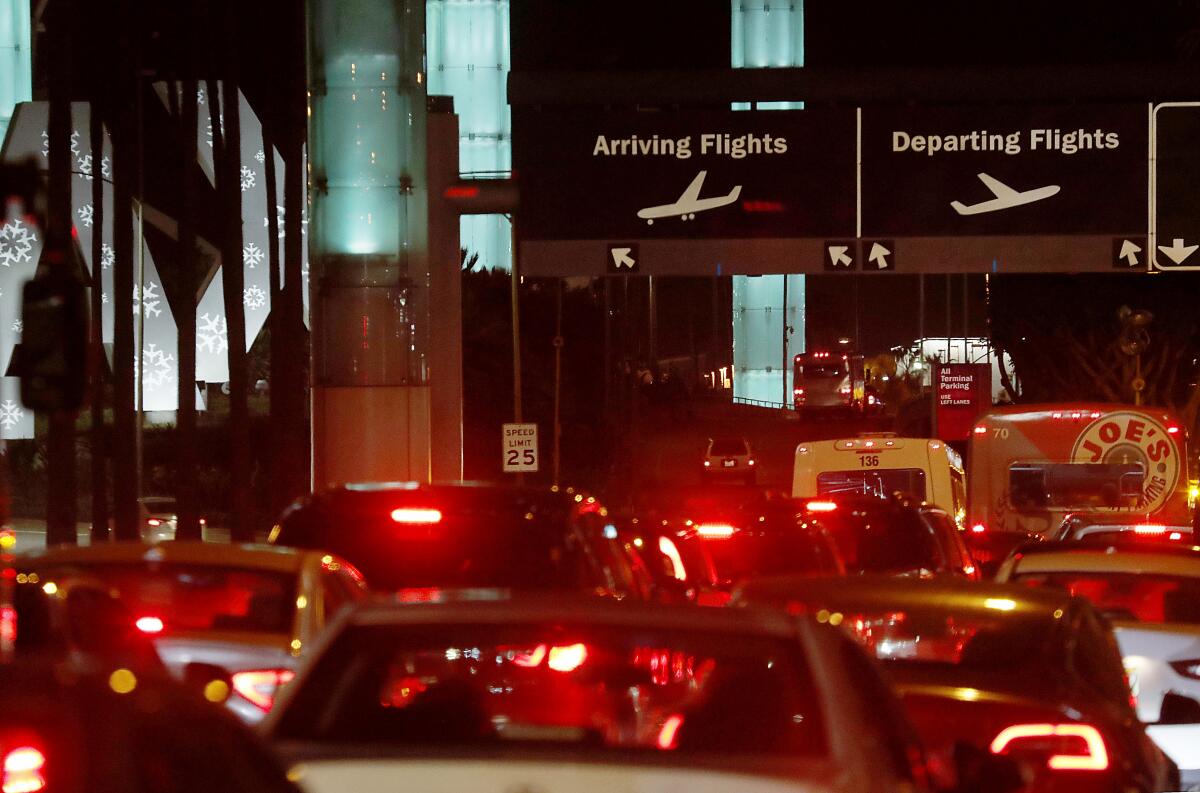 Traffic backs up on Century Blvd. as holiday travel picks up at Los Angeles International Airport on Tuesday.