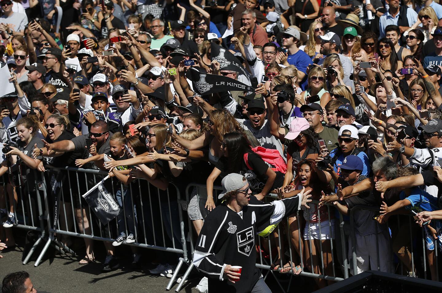 Kings player Anze Kopitar greets fans as the team arrives in Manhattan Beach.