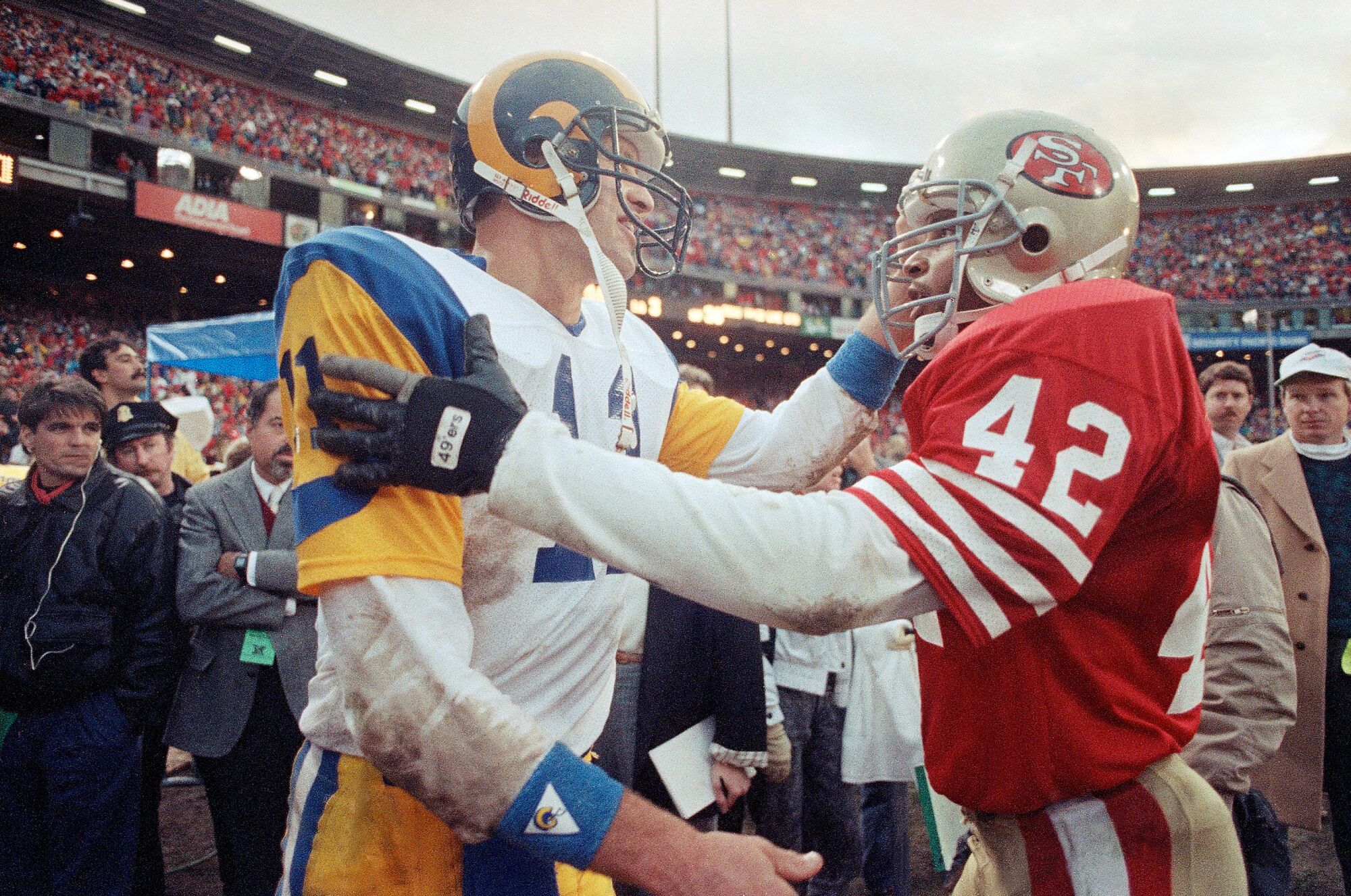 San Francisco 49ers safety Ronnie Lott, right and Los Angeles Rams quarterback Jim Everett greet each other after the game