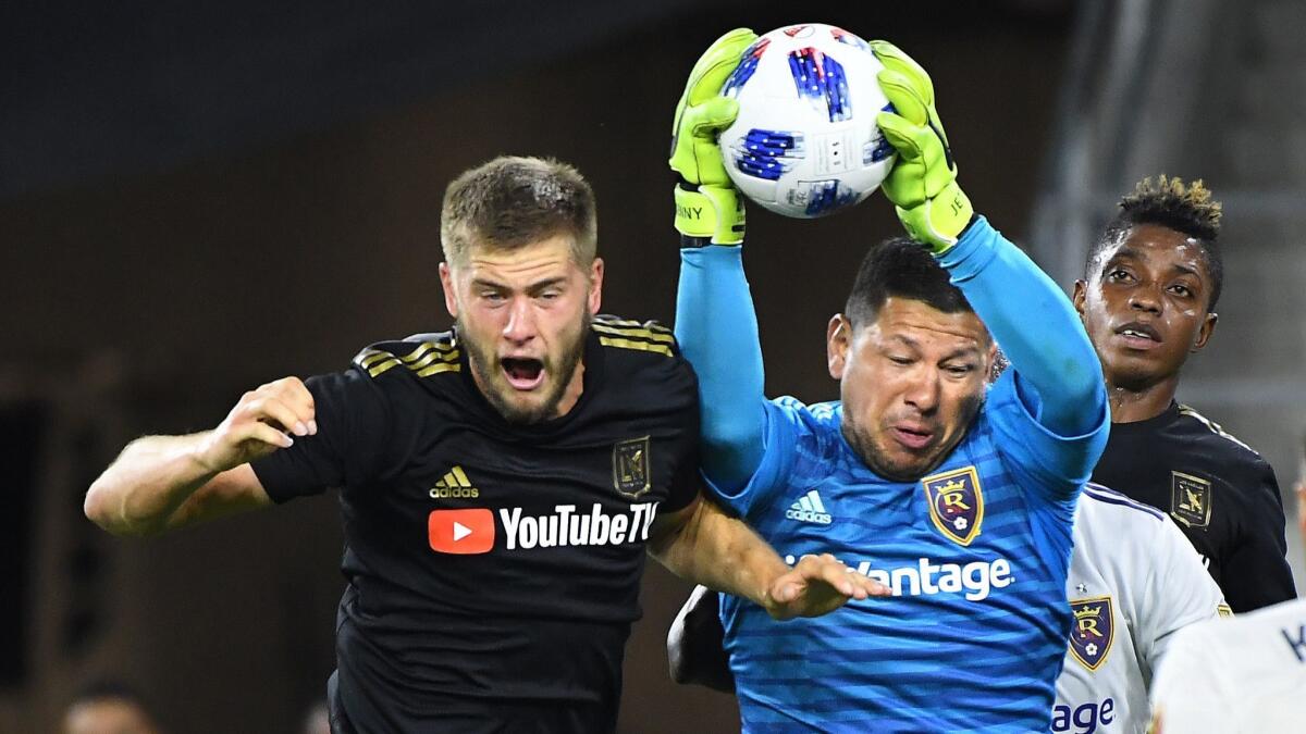 LAFC's Walker Zimmerman tries to head the ball into the net but RSL goalie Nick Rimando catches the cross.