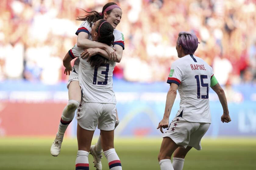 American midfielder Rose Lavelle leaps into the arms of Alex Morgan as they, along with Megan Rapinoe, celebrate a goal by Lavelle during the second half Sunday.