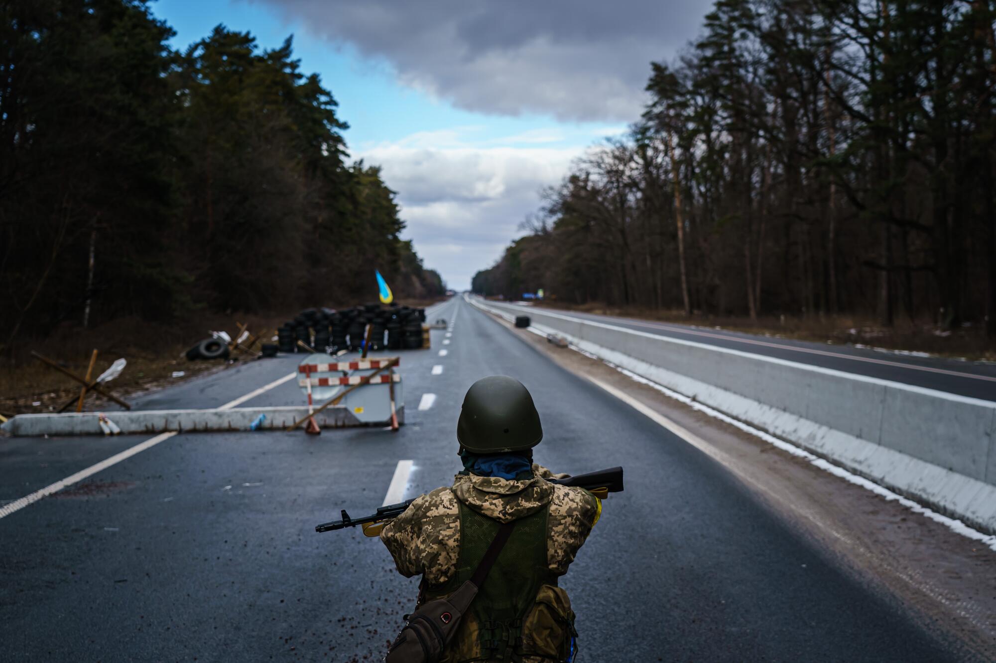 Soldiers stands at a checkpoint near the front line in Brovary, northeast of the capital. 
