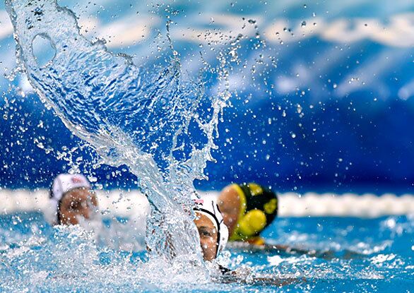 Brenda Villa creates a steep wave of water as she celebrates scoring a goal late in a women's water polo semifinal match against Australia. The U.S. squad defeated Australia 9-8 and will play in the gold medal game at Beijing's Yingdong Natatorium.