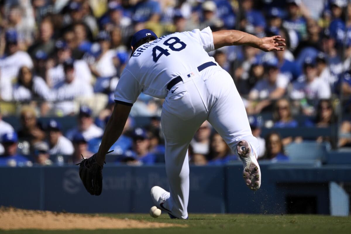 Dodgers relief pitcher Brusdar Graterol can't field an RBI bunt single by Jake McCarthy during the ninth inning.