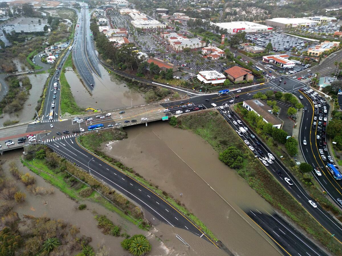 Rain overwhelmed and shut down the State Route 78 in Carlsbad, CA during heavy downpours Monday morning.