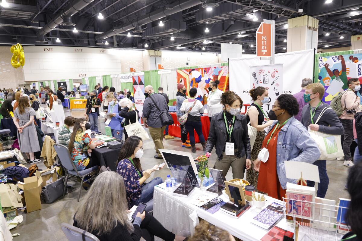 People gather in a room at a conference.