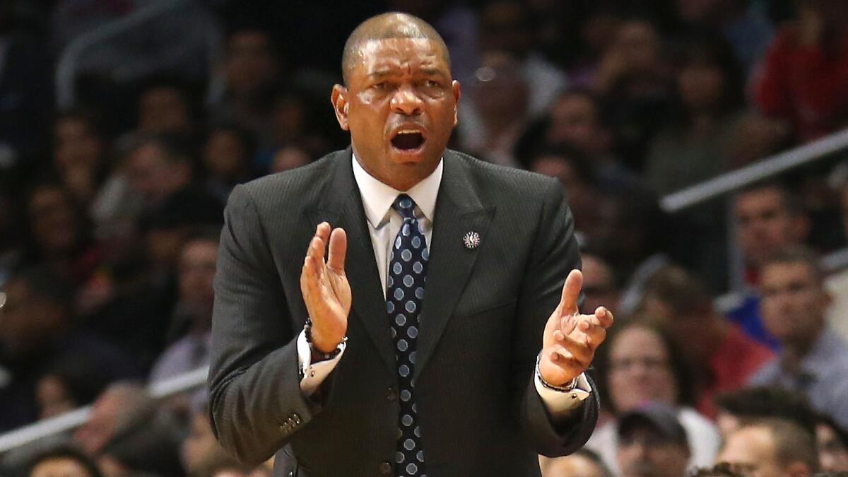 Clippers Coach Doc Rivers exhorts his players during an 89-85 loss to the San Antonio Spurs on Monday.