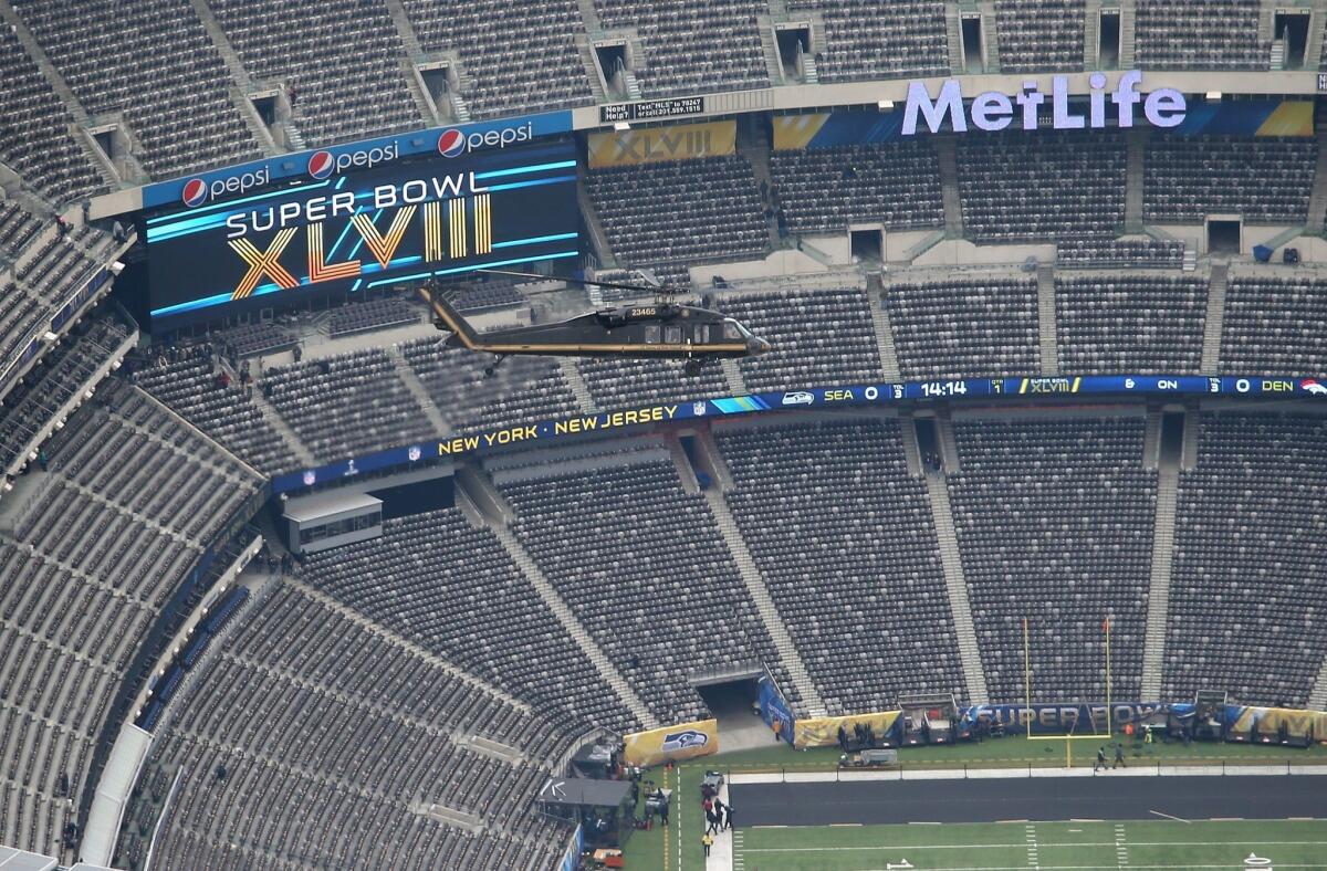 A Customs and Border Protection helicopter flies over MetLife Stadium on Friday during preparations for Super Bowl XLVIII.